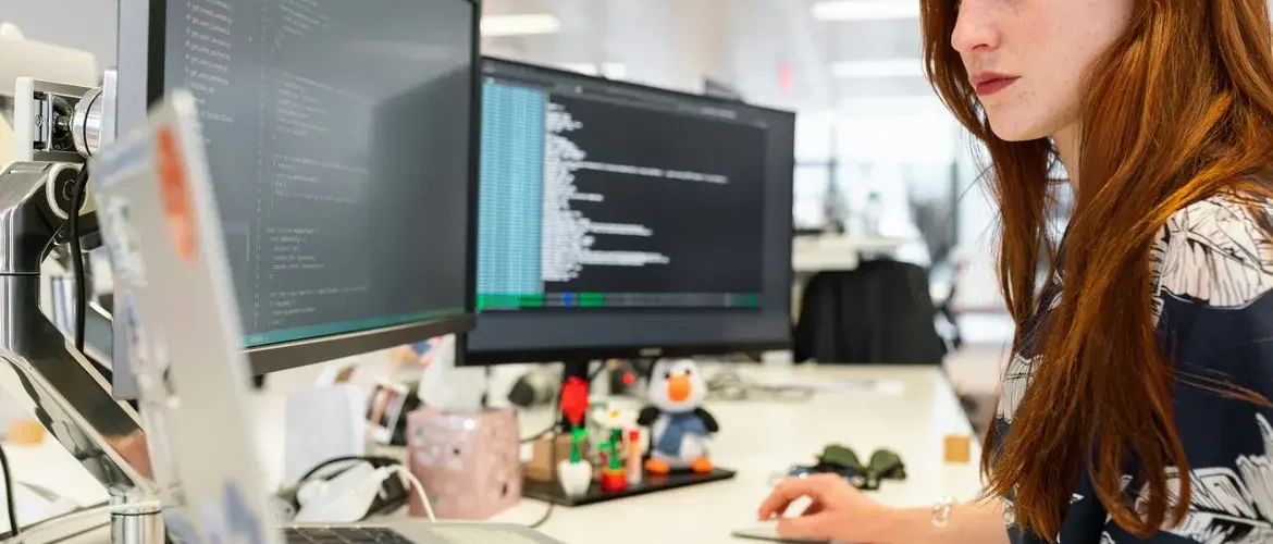 software developer girl coding at computer