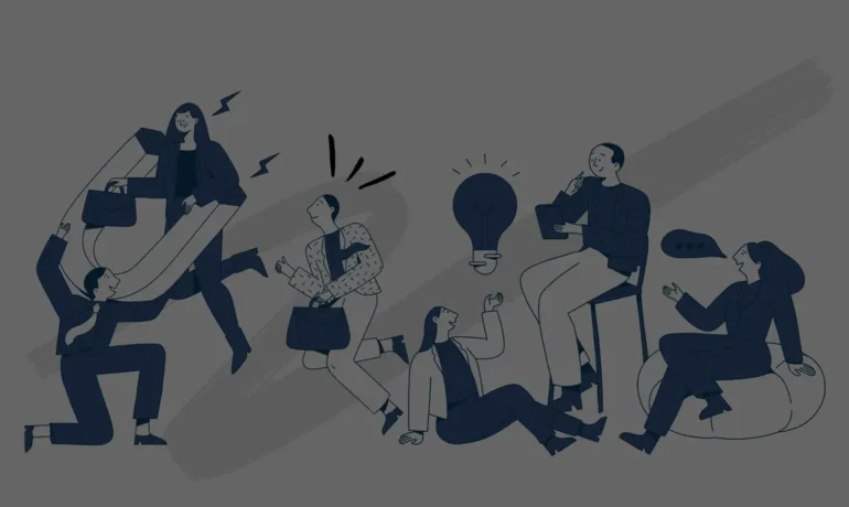 group of people brainstorming ideas around a table with a glowing light bulb in the center
